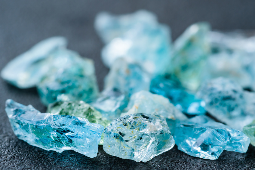 A collection of blue uncut aquamarine gemstones.