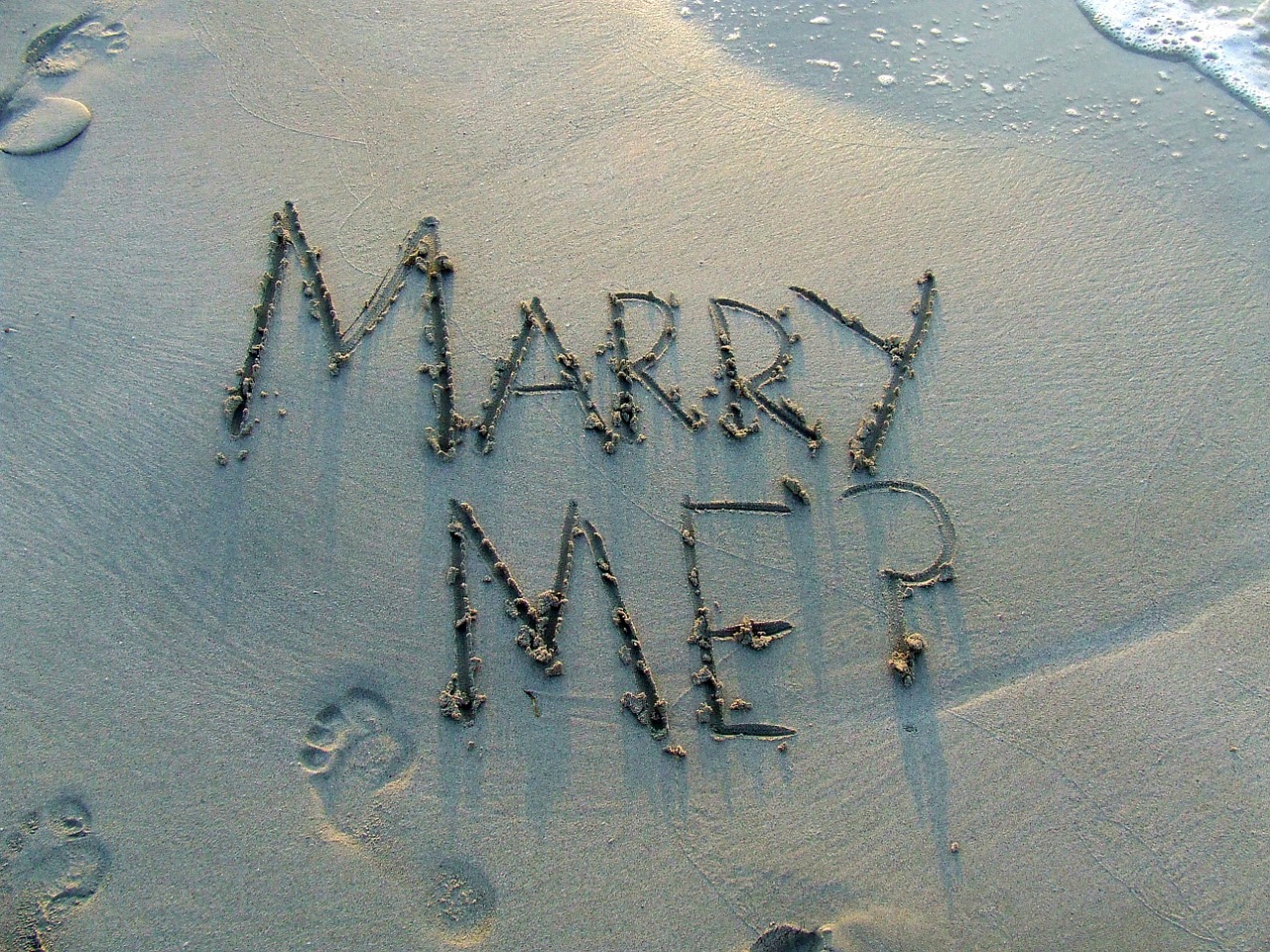 Marry Me? written in sand